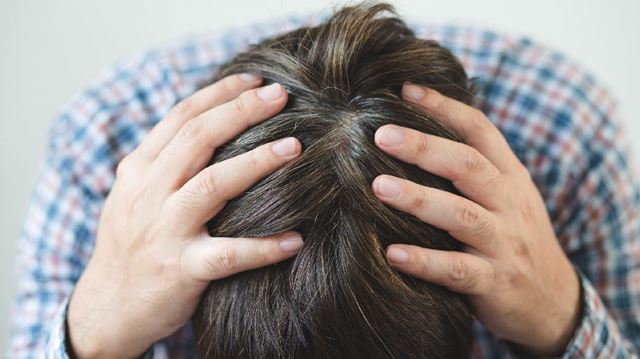 man with head in hands
